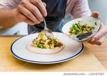 Chef at the kitchen preparing bean porridge with cauliflower and vegetables Chef at the kitchen preparing bean porridge with cauliflower and vegetables 116347907