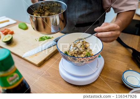 Chef at the kitchen preparing healthy quinoa bowl with avocado Chef at the kitchen preparing healthy quinoa bowl with avocado 116347926