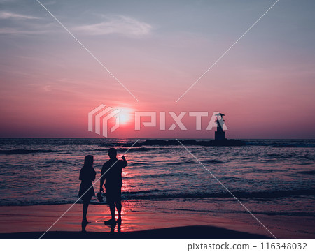 A lighthouse in the ocean during a beautiful sunset A lighthouse in the ocean during a beautiful sunset 116348032