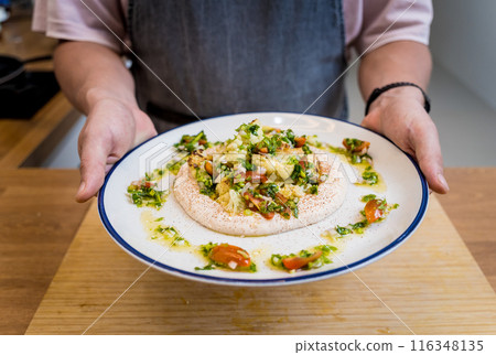 Tasty bean porridge with cauliflower and vegetables on white plate Tasty bean porridge with cauliflower and vegetables on white plate 116348135