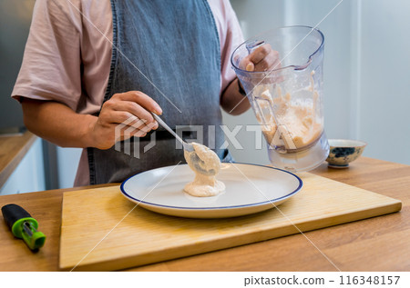 Chef at the kitchen preparing bean porridge with cauliflower and vegetables Chef at the kitchen preparing bean porridge with cauliflower and vegetables 116348157