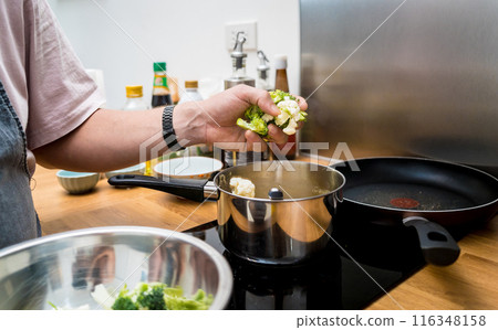 Chef at the kitchen preparing lentils soup with cauliflower and broccoli 116348158