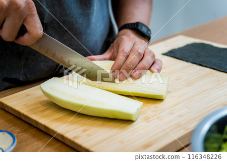 Chef at the kitchen preparing grilled eggplants with garlic Chef at the kitchen preparing grilled eggplants with garlic 116348226