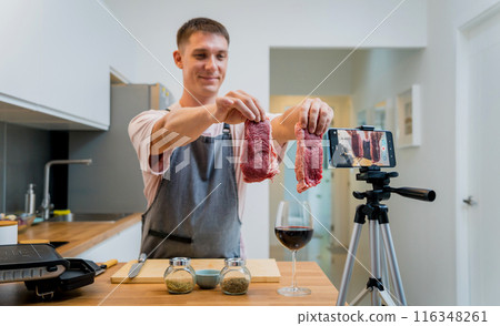The chef is broadcasting live from workshop how to prepare a beef steaks on the electric grill The chef is broadcasting live from workshop how to prepare a beef steaks on the electric grill 116348261