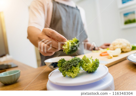 Chef at the kitchen preparing lentils soup with cauliflower and broccoli Chef at the kitchen preparing lentils soup with cauliflower and broccoli 116348304