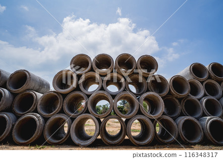 A stack of concrete ring pipes piled and creating a symmetrical arrangement A stack of concrete ring pipes piled and creating a symmetrical arrangement 116348317