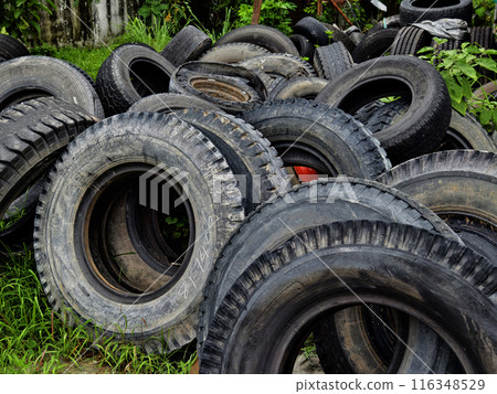A stack of used tires is placed one on top of the other 116348529
