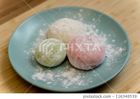 Different color delicious Japanese mochi on the blue plate Different color delicious Japanese mochi on the blue plate 116348539