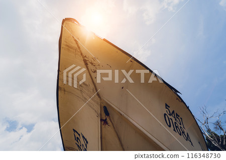 Old and rusty motor boats on a landfill surrounded by tropical forest 116348730