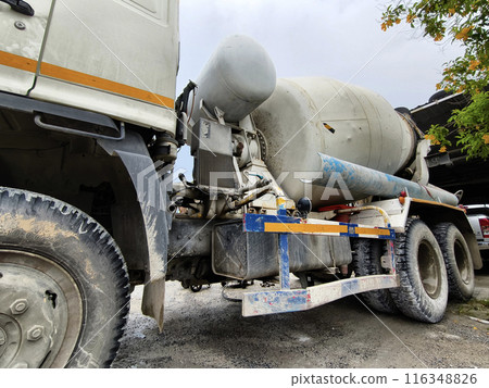 A concrete mixer truck parked beside of a concrete factory A concrete mixer truck parked beside of a concrete factory 116348826