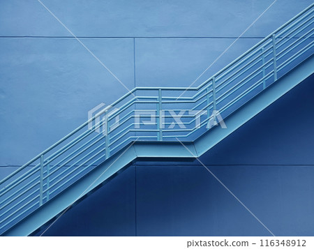 A set of stairs ascending a large blue wall A set of stairs ascending a large blue wall 116348912