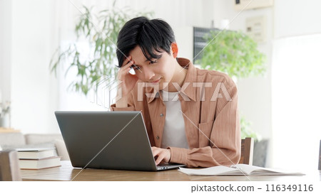 A man thinking at a computer 116349116