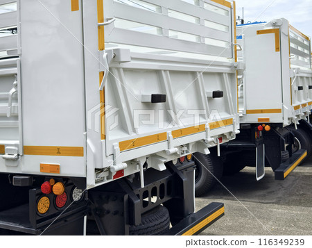 Two trucks are parked beside each other in a parking area Two trucks are parked beside each other in a parking area 116349239