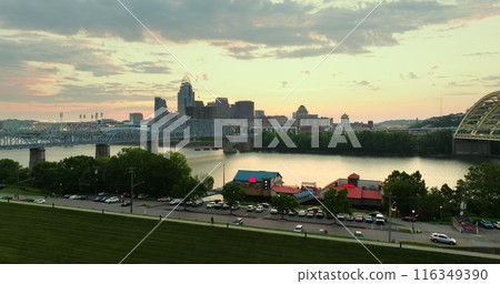 Evening urban landscape of downtown district of Cincinnati in Ohio state, USA. American city skyline with brightly illuminated high commercial buildings 116349390
