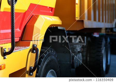 close-up side view of a tri axle dump truck close-up side view of a tri axle dump truck 116350409