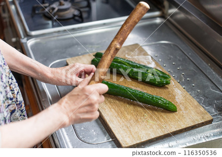 Senior woman making smashed cucumbers 116350536