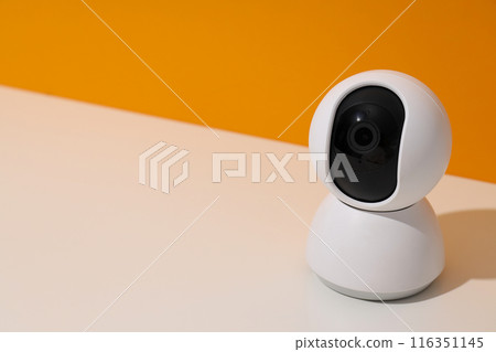 White surveillance camera on a light background 116351145