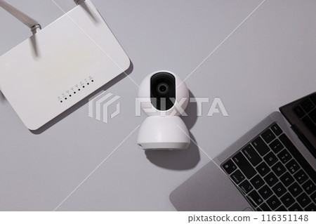 A video surveillance camera with a laptop and Wi-Fi router 116351148