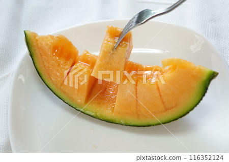 Melon with a fork Melon with a fork 116352124