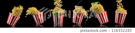 Flying popcorn from striped bucket isolated on black background Flying popcorn from striped bucket isolated on black background 116352285