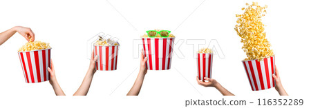 Woman hand taking popcorn from striped bucket isolated on white background Woman hand taking popcorn from striped bucket isolated on white background 116352289