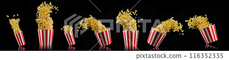Flying popcorn from striped bucket isolated on black background 116352335
