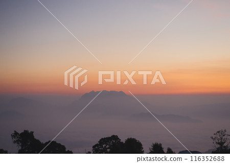 travel and people activity concept with twilight sky before sunrise with mountain and fog on foreground travel and people activity concept with twilight sky before sunrise with mountain and fog on foreground 116352688