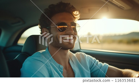 Driving charm charisma: a handsome man behind the wheel of his car - showcasing the sophistication and allure of a man at the helm of his vehicle, exuding poise and power on the open road. 116353681