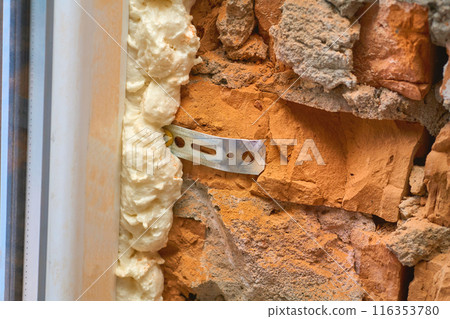 Construction foam. Installation of a metal plastic window,door,brick wall.  116353780