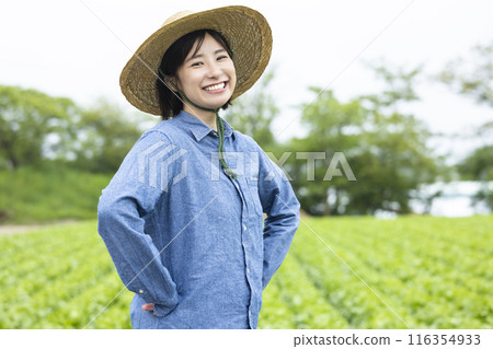 Farmer woman wearing a straw hat Farmer woman wearing a straw hat 116354933
