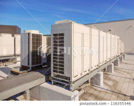 Outdoor unit of air conditioning facility on the roof of a building and blue sky Outdoor unit of air conditioning facility on the roof of a building and blue sky 116355346
