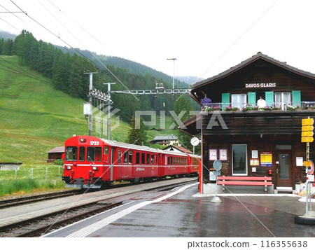 A Davos Line train parked at the mountain hut-style Davos Glaris station in the early afternoon A Davos Line train parked at the mountain hut-style Davos Glaris station in the early afternoon 116355638