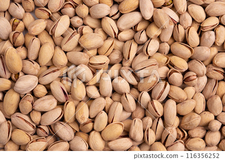 background of unpeeled almond nuts, close up 116356252