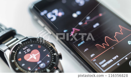 Close-up of a smartphone and smartwatch displaying health and fitness data, emphasizing digital health monitoring. 116356828