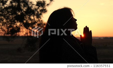 girl woman praying at sunset, hand sunset faith pain, asking heaven for help, spiritual sunset meditation, serene prayer moment, dusk reflection solitude, sunset prayer tranquility, peaceful evening 116357551