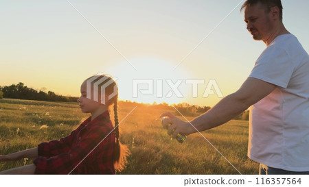 Father protect child with spray against mosquitoes, midges. Man dad spray on child kid daughter protect skin body from bites of mosquitoes, midges. Necessary measures for comfortable pastime in nature Father protect child with spray against mosquitoes, midges. Man dad spray on child kid daughter protect skin body from bites of mosquitoes, midges. Necessary measures for comfortable pastime in nature 116357564