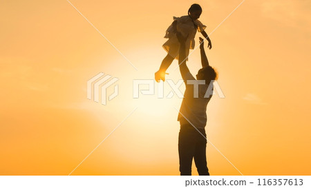 father throws child kid daughter into sky, silhouette happy family, children dream flying airplane pilot, father daughter fun, playful parenting, joyful child, family bonding time, sunset silhouette 116357613