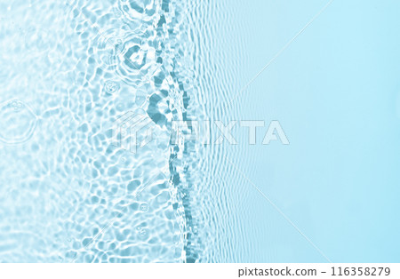 Blue water wave texture background with copy space. Featuring dynamic wave pattern and delicate splashe, the crystal-clear water is highlighted by the play of light and shadow. Blue water wave texture background with copy space. Featuring dynamic wave pattern and delicate splashe, the crystal-clear water is highlighted by the play of light and shadow. 116358279