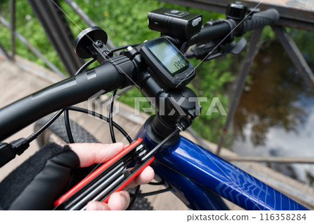 Setting up and adjusting a new bicycle with the hexagon key. Mountain bike rider customizes the bike to fit his or her needs. Setting up and adjusting a new bicycle with the hexagon key. Mountain bike rider customizes the bike to fit his or her needs. 116358284
