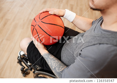 Top view closeup of young sportsman with disability using wheelchair while playing basketball copy space 116358547
