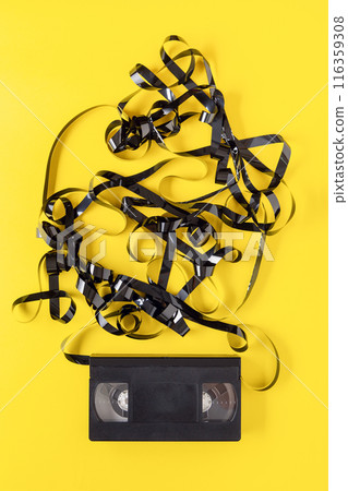 classic VHS videotape on a yellow background. 116359308