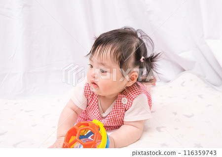 [Baby with twin tails starting to crawl] 116359743