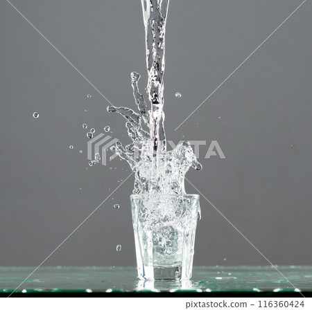Crown Water splash on object to create shape form fluttering in droplet and wave. Crown water to object make curve drop explosion in ripple motion. Grey background isolated 116360424
