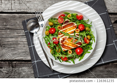 salad with grilled halloumi greek cheese in bowl 116361235