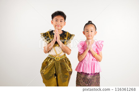 Portrait Thailand kid boy and girl smiling traditional Thai dress costume posing to pay respect in studio isolated white background, Happy primary and kindergarten children sawasdee symbol or welcome Portrait Thailand kid boy and girl smiling traditional Thai dress costume posing to pay respect in studio isolated white background, Happy primary and kindergarten children sawasdee symbol or welcome 116361268