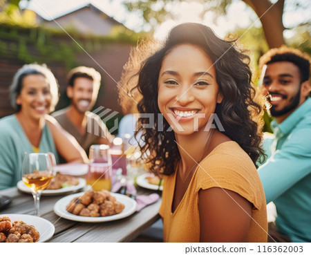 Happy Woman Celebrating Birthday with Family and Friends in a Backyard Party 116362003