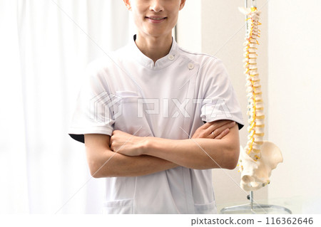 Asian man in a white coat with his arms crossed Asian man in a white coat with his arms crossed 116362646