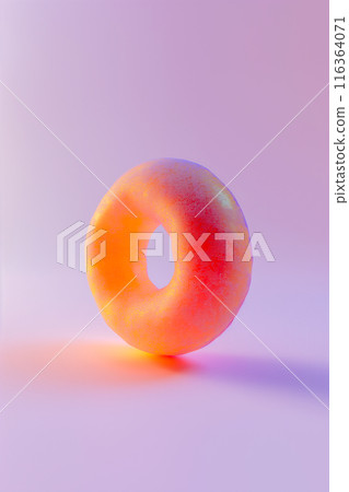 A donut with a sprinkle on top is shown on a purple background 116364071