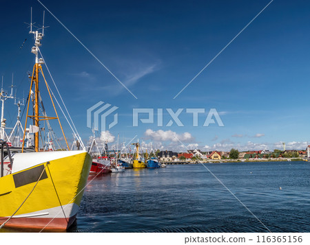 Motorboat and cutter docked a the marina 116365156