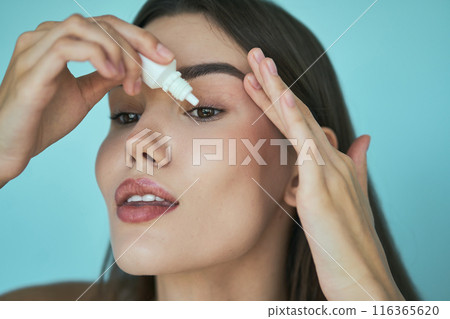 Woman Applying Eye Drops for Dry Eye Relief Close-Up Woman Applying Eye Drops for Dry Eye Relief Close-Up 116365620